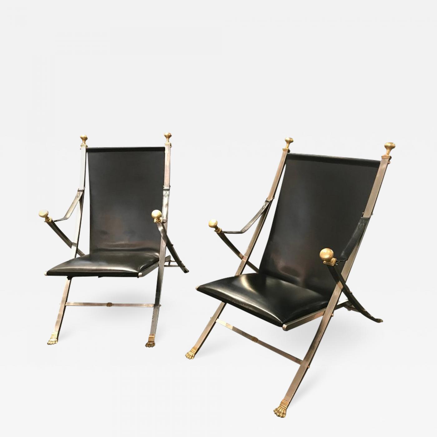 Pair of polished steel and leather folding chairs in the style of Maison Jansen